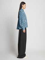 Side full length image of model wearing Printed Crepe De Chine Top in BLUE MULTI