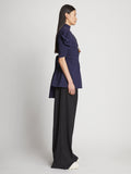 Side full length image of model wearing Matte Viscose Crepe Belted Top in NAVY