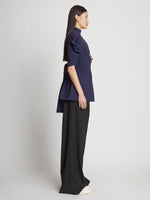 Side full length image of model wearing Matte Viscose Crepe Belted Top in NAVY