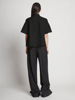 Back full length image of model wearing Poplin Pintuck Top in BLACK