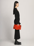 Image of model wearing Suede Braid Bag in TOMATO