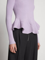 Detail image of model wearing Fluted Rib Knit Peplum Sweater in LAVENDER