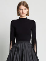 Front cropped image of model wearing Matte Viscose Knit Fringe Sweater in BLACK