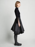 Side full length image of model wearing Matte Viscose Knit Fringe Sweater in BLACK