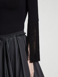 Detail image of model wearing Matte Viscose Knit Fringe Sweater in BLACK