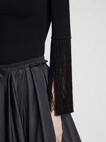 Detail image of model wearing Matte Viscose Knit Fringe Sweater in BLACK