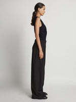 Side image of model wearing Matte Viscose Crepe Spiral Top in navy