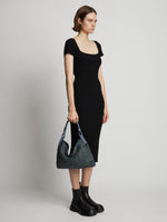 Image of model carrying Minetta Raffia Bag in dove grey