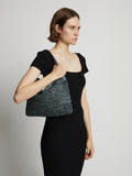 Image of model carrying Minetta Raffia Bag in dove grey