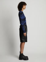 Side image of model wearing Marled Stripe Knit Sweater in cerulean/black