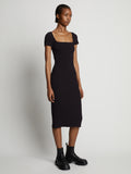 Side image of model wearing Rib Knit Short Sleeve Dress in black