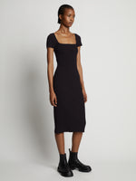 Side image of model wearing Rib Knit Short Sleeve Dress in black