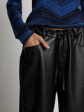 Detail image of model wearing Faux Leather Shorts in black