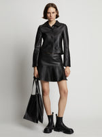 Front image of model wearing Leather Ruffle Mini Skirt in black