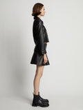 Side image of model wearing Leather Ruffle Mini Skirt in black