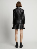 Back image of model wearing Leather Ruffle Mini Skirt in black