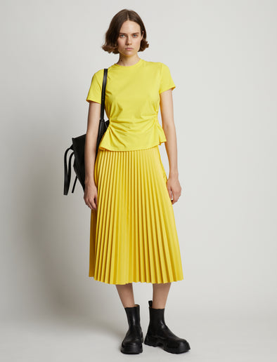 Front image of model wearing Faux Leather Pleated Midi Skirt in sun