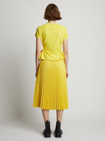 Back image of model wearing Faux Leather Pleated Midi Skirt in sun