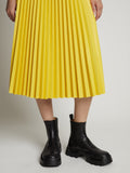 Detail image of model wearing Faux Leather Pleated Midi Skirt in sun