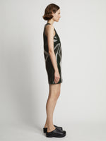 Side image of model wearing Vinyl V-Neck Shift Dress in pine