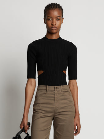 Cropped front image of model wearing Rib Knit Cut Out Sweater in black