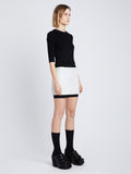 Side image of model wearing Boucle Tweed Skirt in off white