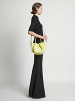 Image of model wearing Small Ruched Crossbody Tote in LEMONGRASS