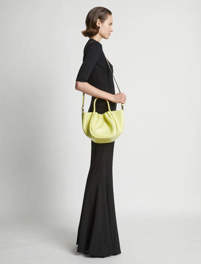 Image of model wearing Small Ruched Crossbody Tote in LEMONGRASS