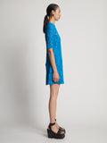 Side image of model wearing Lace Dress in turquoise