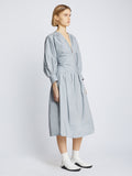 Side image of model wearing Poplin V-Neck Dress in light blue