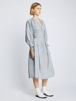 Side image of model wearing Poplin V-Neck Dress in light blue