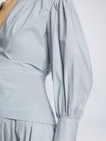 Detail image of model wearing Poplin V-Neck Dress in light blue