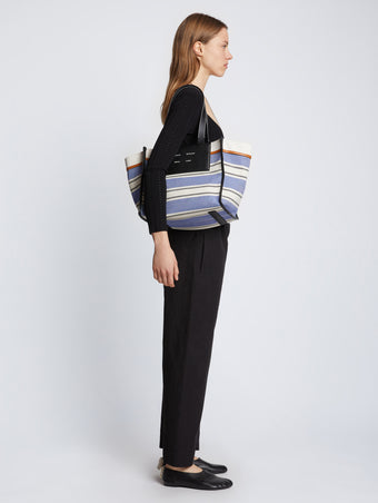 Image of model carrying Large Morris Stripe Canvas Tote in BLACK/WHITE/COBALT on shoulder