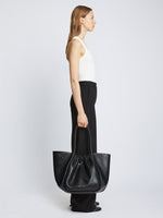 Image of model carrying Carved Python XL Ruched Tote in BLACK in hand