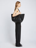 Image of model carrying Carved Python XL Ruched Tote in BLACK on shoulder