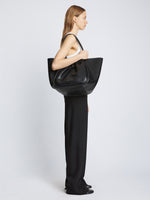 Image of model carrying Carved Python XL Ruched Tote in BLACK on shoulder