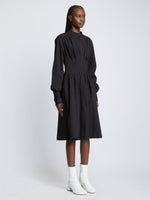 Side full length image of model wearing Eco Poplin Shirt Dress in BLACK