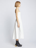 Side full length image of model wearing Eco Poplin Pintuck Dress in WHITE