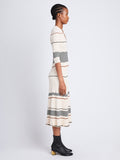 Side full length image of model wearing Wavy Stripe Rib Knit Dress in ECRU MULTI