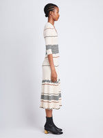 Side full length image of model wearing Wavy Stripe Rib Knit Dress in ECRU MULTI