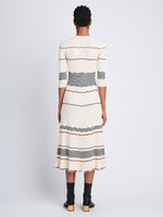 Back full length image of model wearing Wavy Stripe Rib Knit Dress in ECRU MULTI