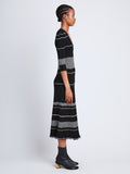 Side full length image of model wearing Wavy Stripe Rib Knit Dress in BLACK MULTI