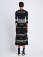 Back full length image of model wearing Wavy Stripe Rib Knit Dress in BLACK MULTI