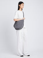 Image of model wearing Baxter Suede Bag in STEEL