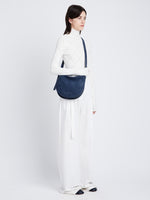 Image of model wearing Medium Baxter Suede Bag in SLATE BLUE