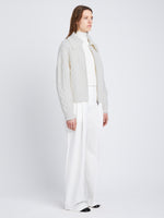 Side full length image of model wearing Relaxed Chunky Cable Zip Sweater in OFF WHITE