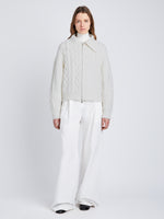 Front full length image of model wearing Relaxed Chunky Cable Zip Sweater in OFF WHITE with sweater zipped