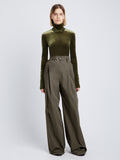 Front full length image of model wearing Stretch Velvet Turtleneck Top in MILITARY