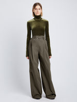 Front full length image of model wearing Stretch Velvet Turtleneck Top in MILITARY