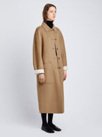 Side full length image of model wearing Reversible Double Face Coat in CAMEL / OFF WHITE on CAMEL side